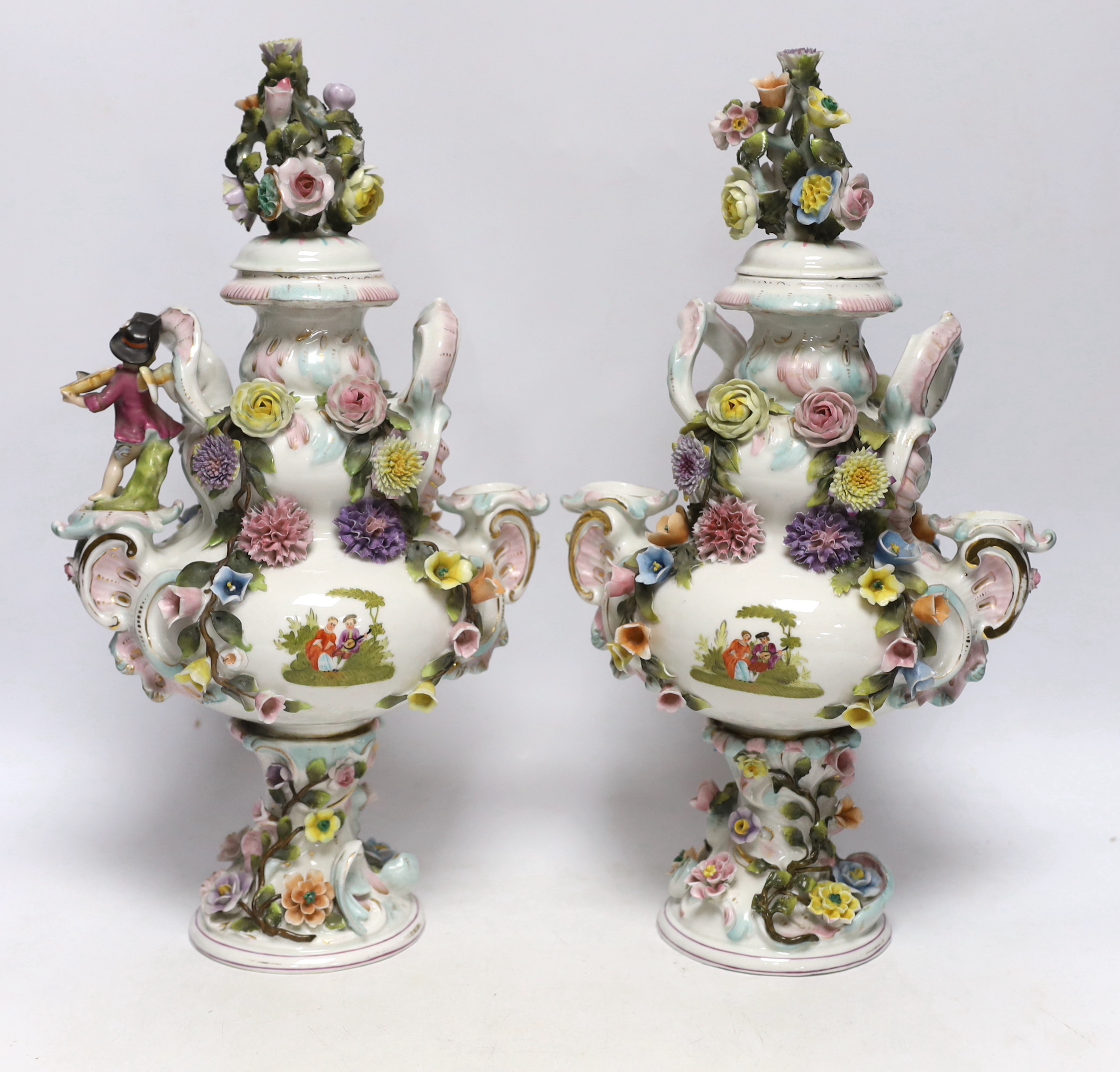 A pair of Sitzendorf floral encrusted and figural vases and covers, late 19th century, 36cm high
